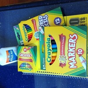 A bundle with Crayola crayons, markers, and colored pencils.  Glue and notebook